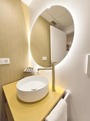 a bathroom with a white sink and a mirror at Apartamentos Las Ciencias U in Valencia