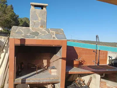 an outdoor pizza oven with a stone wall at Alto Oasis in Siete Aguas