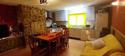 a kitchen with a table and chairs in a room at Alto Oasis in Siete Aguas