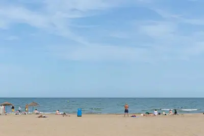 a group of people on a beach with the ocean at Ca Celieta Beach I in Valencia