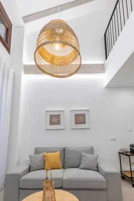 a living room with a couch and a chandelier at Ca Celieta Beach III in Valencia