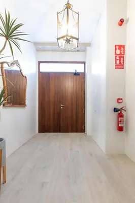 a hallway with a wooden door in a room at Ca Celieta Beach III in Valencia