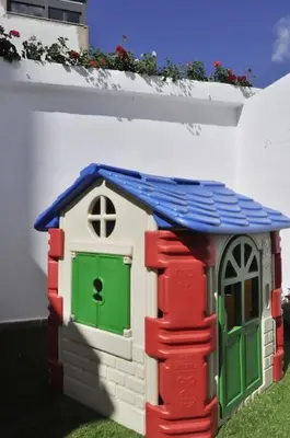 a toy house with a green door and a blue roof at Family Century House with terrace and parking in Valencia