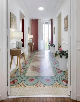 a hallway with a table and a rug at Family Century House with terrace and parking in Valencia