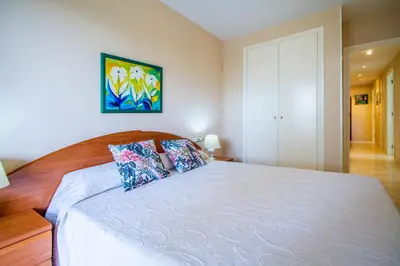 a bedroom with a large white bed with two pillows at ESPACIO 3 - Primera Línea de Playa in Cullera