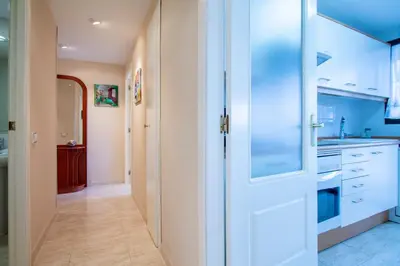 a kitchen with white cabinets and a door at ESPACIO 3 - Primera Línea de Playa in Cullera