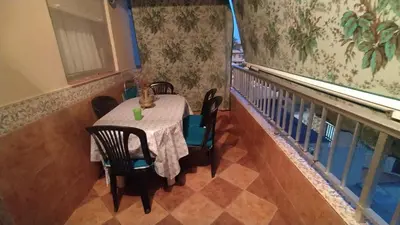a table and chairs in a room with a balcony at Apartamento Playero in Tavernes de Valldigna