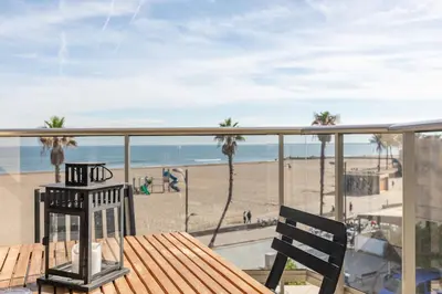 a balcony with a table and a view of the beach at ApartUP Patacona Deluxe in Valencia