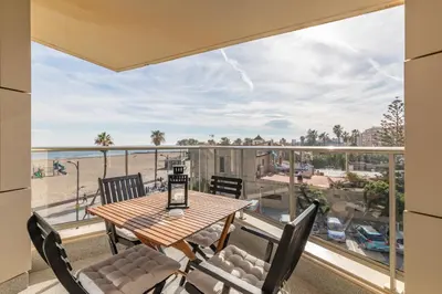 a balcony with a table and chairs and a view of the beach at ApartUP Patacona Deluxe in Valencia