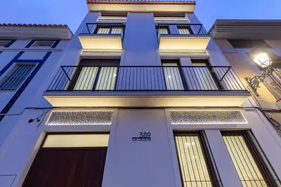 a building with a balcony on the side of it at Ca Celieta Beach IV in Valencia