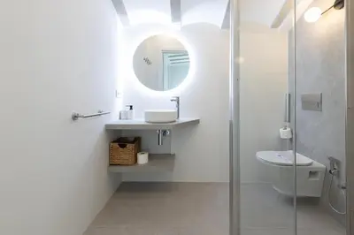 a bathroom with a sink and a toilet and a mirror at Ca Celieta Beach IV in Valencia