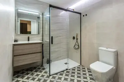 a bathroom with a shower and a toilet and a sink at Suite Deluxe Valencia - AIORA Apartments in Valencia