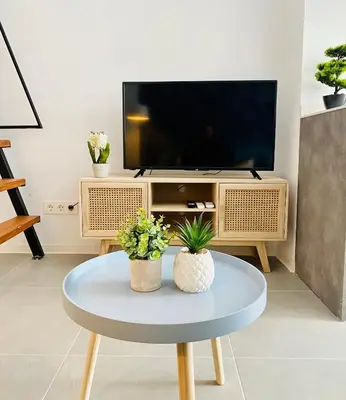 a living room with a tv and a coffee table at Modern Designed Loft in Russafa (SOHO) in Valencia