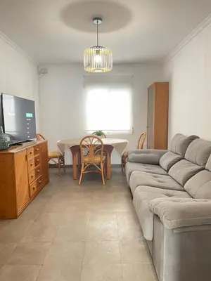 a living room with a couch and a table at UIM Mediterraneo PB Miguel Hernandez Wifi in Puerto de Sagunto