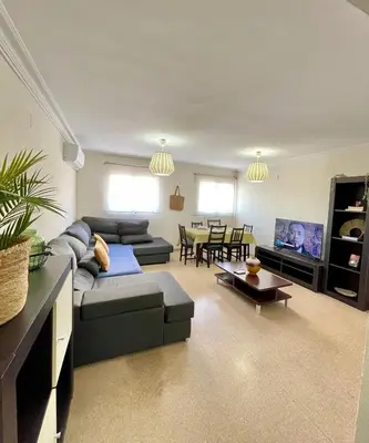 a living room with a couch and a table at UIM Mediterraneo PB Dolores Ibarruri Wifi in Puerto de Sagunto