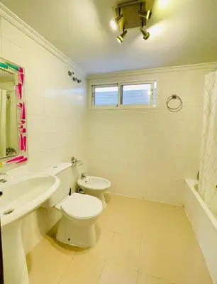 a white bathroom with a toilet and a sink at UIM Mediterraneo PB Dolores Ibarruri Wifi in Puerto de Sagunto