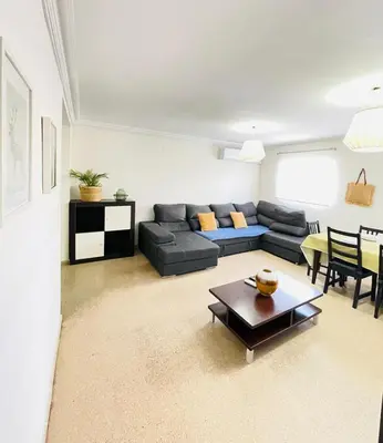 a living room with a couch and a table at UIM Mediterraneo PB Dolores Ibarruri Wifi in Puerto de Sagunto