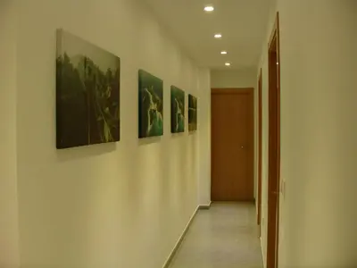 a hallway with four paintings on the walls at Playa y Montaña Faura-Valencia in Faura