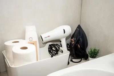 a bathroom with a hair dryer and toilet paper at lifecoliving valencia loft BR in Valencia