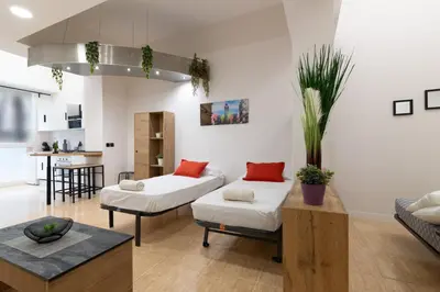 a living room with two beds and a kitchen at Spacious OCEANOGRAFIC Flats Valencia in Valencia