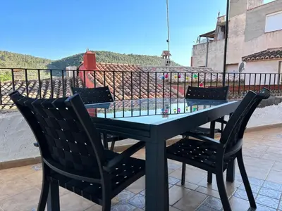 a table and chairs on top of a balcony at Piso en Vall de Almonacid con vistas, aire acondicionado, Wifi y Smart TV in Vall de Almonacid