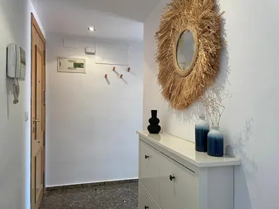 a room with a mirror and a cabinet with vases on it at SingularStays El Grao in Valencia