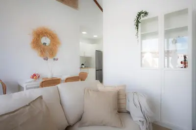 a living room with a white couch and a window at SingularStays Vivons in Valencia