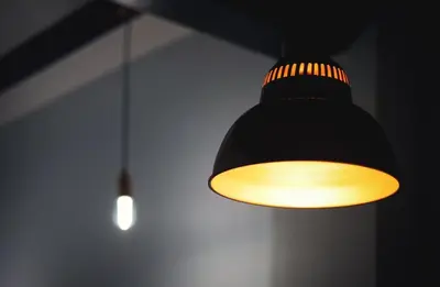 a black and yellow light hanging from a ceiling at Cozy apartment near the center, Torres de Serrano in Valencia