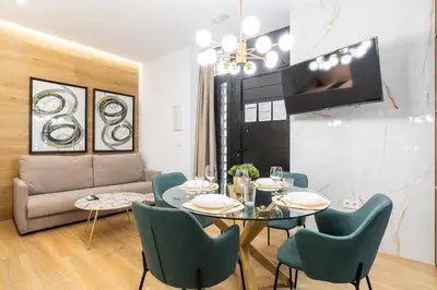 a living room with a table and chairs and a couch at Anelsa Torres de Serranos 3 in Valencia