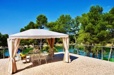 a white tent on a patio with a table and chairs at Casa Navajas in Jérica