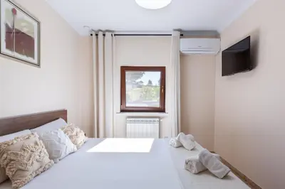 a bedroom with a white bed and a television at Casa Navajas in Jérica