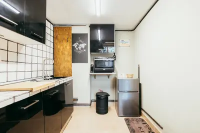 a kitchen with a refrigerator and a microwave at Apartment Ruzafa Roots, 12 min to Centre, Smart TV, Wine in Valencia