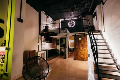 a room with a spiral staircase and a kitchen at Apartment Ruzafa Roots, 12 min to Centre, Smart TV, Wine in Valencia