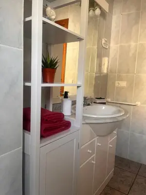 a white bathroom with a sink and a mirror at Apartamento La Ermita in Chulilla