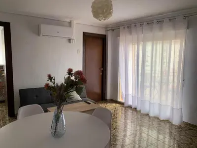 a living room with a vase of flowers on a table at Sagunto 2 in Sagunto