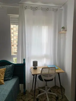 a room with a table and a chair and a window at Sagunto 2 in Sagunto