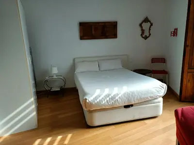 a bedroom with a bed in the corner of a room at Tossal in Valencia