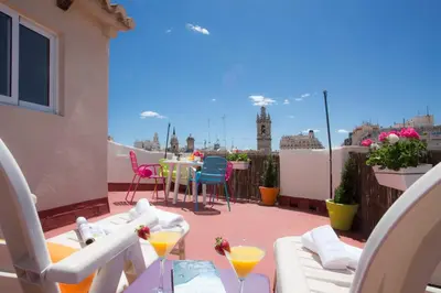a patio with a table and chairs on a balcony at Tossal in Valencia