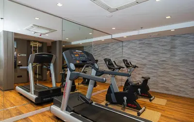 a gym with several tread machines in a room at SH Colón Valencia in Valencia
