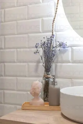 a vase of flowers sitting on a table next to a sink at RA - Stylish city loft - Walk to the best of Valencia in Valencia