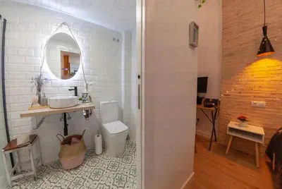 a bathroom with a toilet and a sink and a mirror at RA - Stylish city loft - Walk to the best of Valencia in Valencia
