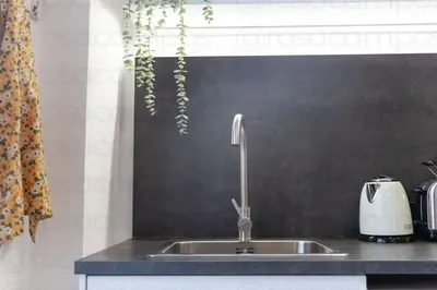 a kitchen sink with a faucet in a kitchen at RB - Urban loft retreat, comfort & good location in Valencia