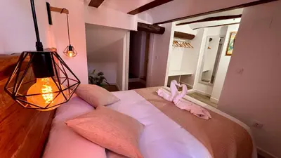 a bedroom with a bed with a pink animal on it at La Casucha de Chulilla in Chulilla