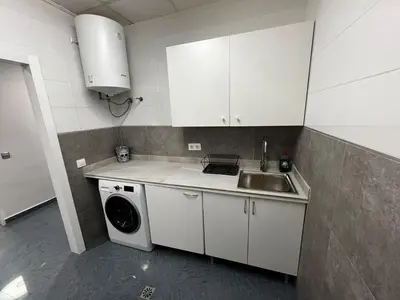 a kitchen with a sink and a washing machine at RMN TOURIST HOME in Valencia