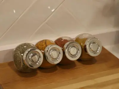 a group of four glass jars sitting on a shelf at Impresionante Apartamento 3 habitaciones by Hometels in Puerto de Sagunto