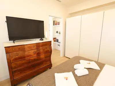 a bedroom with a flat screen tv on a dresser at Impresionante Apartamento 3 habitaciones by Hometels in Puerto de Sagunto