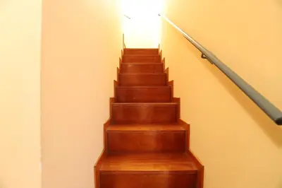 a wooden staircase with a light at the top at Ático con piscina en excelente urbanización by Hometels in Canet de Berenguer