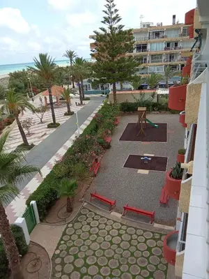 an aerial view of a park with benches and the beach at Apartamento tradicional in Canet de Berenguer