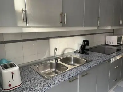 a kitchen with a sink and a counter top at Apartamento Diagonal in Nules
