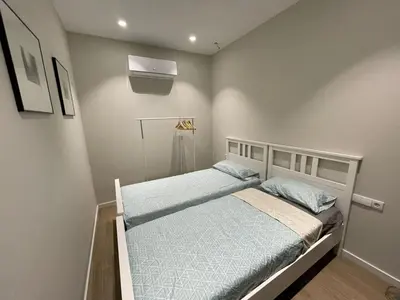 a small bedroom with a bed with blue sheets at Apartamento moderno de 70 metros a 300 metros de la playa in Valencia